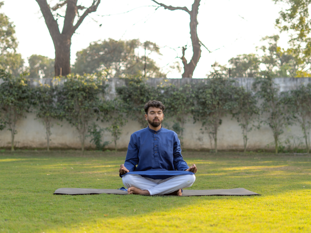 An image of a man meditating in the outdoor