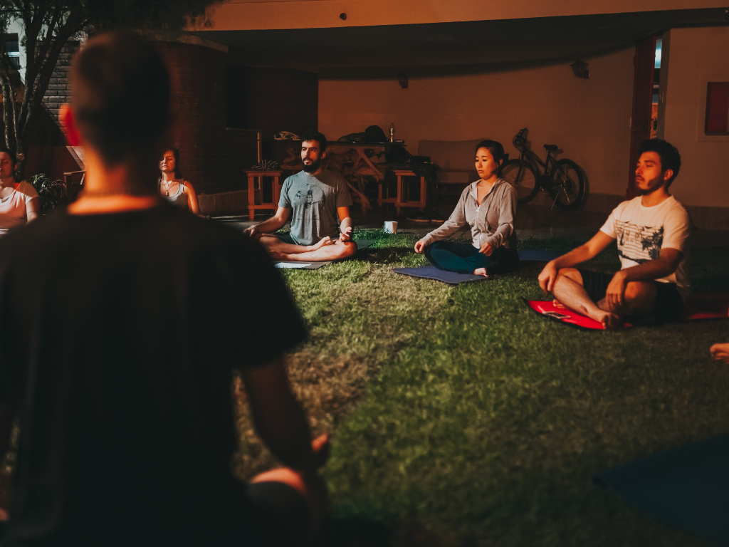 A group of people practicing physical meditation